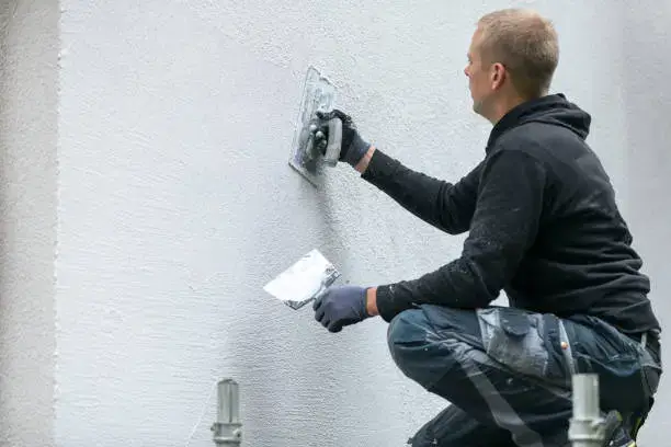 a man patching synthetic stucco