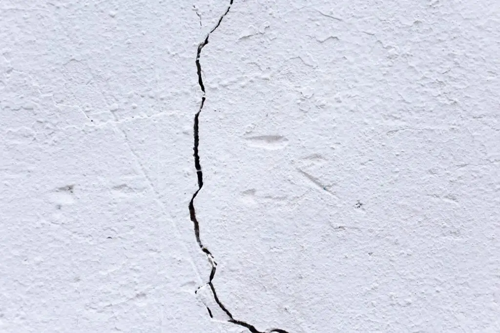 a stucco wall with a crack