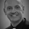 a black and white image of an older bald man