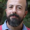 a man with a dark beard